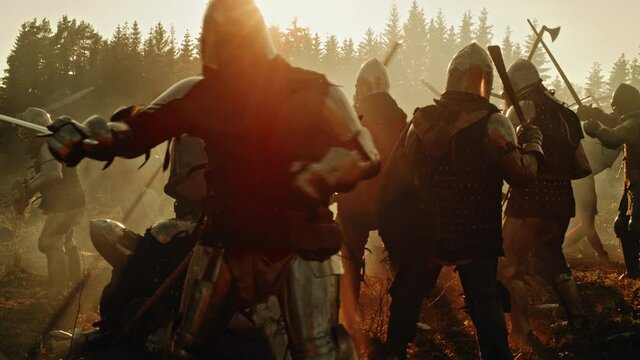 Epic Battlefield: Armies of Medieval Knights Fighting with Swords. Brutal Action Battle of Armored Warrior Soldiers. Dark Ages War, Warfare, Crusade. Cinematic Day Light. Historical Reenactment. Wide