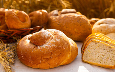 lot of different flavored bread, wheat, rye, on the table in the field outside