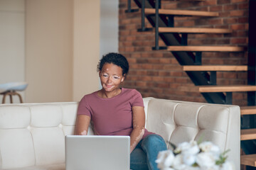 Cute young woman working from home and looking involved