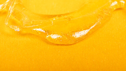 piace golden dab concentrate of cannabis wax close up on yellow background, marijuana resin - obrazy, fototapety, plakaty