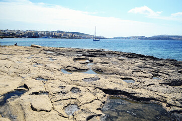 MALTA, VALETTA: Scenic landscape view of the rocky seashore with boats in the sea