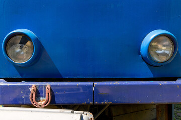 The front part of the retro tram with a horseshoe attached to the bumper. Horseshoe protects the tram from accidents and breakdowns.