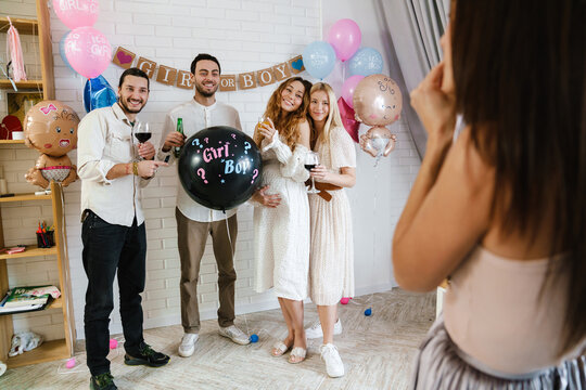 Group Of Happy Friends At A Gender Reveal Baby Shower