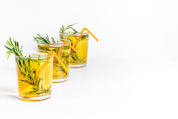 Fresh summer cocktail with cold tea and rosemary in glasses