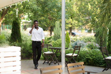 happy african american with a phone on the street