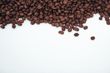 Aromatic dark brown coffee beans isolated on white background. Top view with copy space for your text