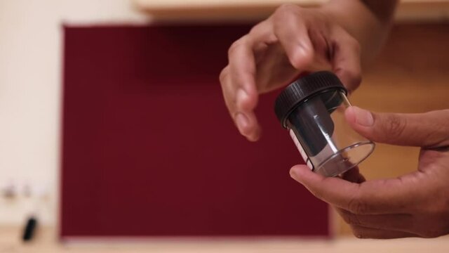 closeup clip of a urine or stool  specimen container 