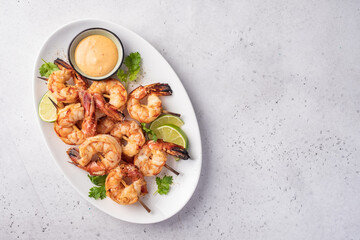 Grilled shrimps. Shrimps skewers, lime and sauce