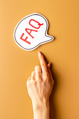 Hands with faq word on paper bubble. Frequently asked questions concept