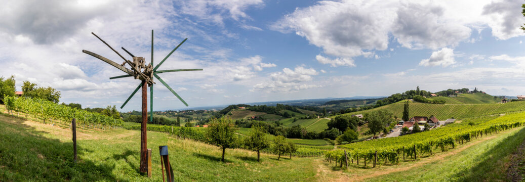 panoramic view summer in southern styria, an old wine growing country in austria named s&uuml;dsteirische weinstrasse. vineyard with windmill called klapotetz  