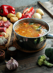 hot soup in a saucepan is steaming. with beef and vegetables. hearty, nutritious dish. dinner