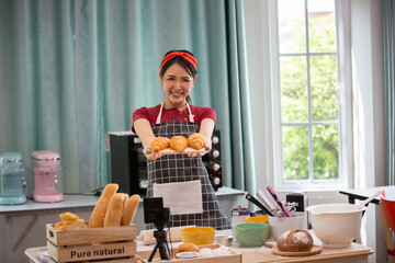 Lifestyle Young asians woman chef wearing apron and baking in home kitchen. Hobby lifestyles concept