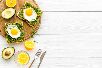 Sandwich with eggs avocado cream and spinach, top view