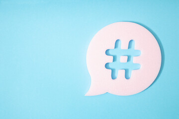 Hashtag in bubble speech on blue background.