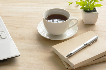 A cup of coffee on a wooden desk
