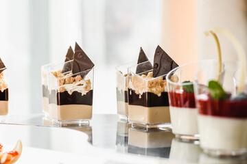 luxury wedding catering, table with modern desserts, cupcakes, sweets with fruit. High quality photo