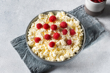 Dieting cottage cheese with fresh raspberry. Healthy breakfast with berries. Dairy products with raspberry. Healthy eating concept