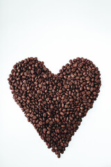 Heart shaped fresh fragrant coffee beans isolated on white background. Copy space. Vertical