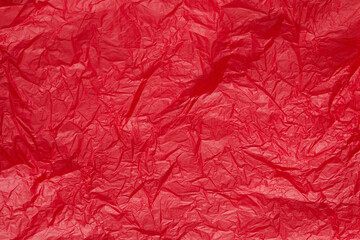 Red crumpled paper or sheet texture background for Design. Wallpaper for text. Copy space.