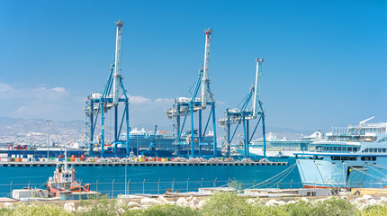 Gantry cranes, container warehouse and ships at cargo terminal of Limassol port, Cyprus