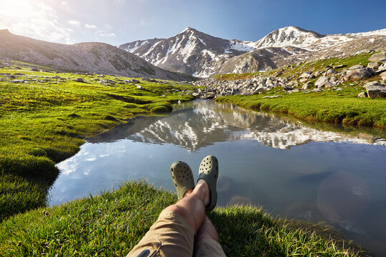 Hiker man rest at mountain lake