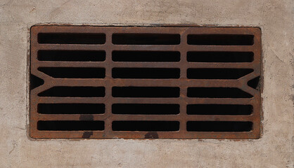 Closeup iron grate of drainage system, image of storm water sewer system on a sunny summer day. Metal drain cover road. Storm water drain. Global warming - obrazy, fototapety, plakaty
