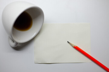 The picture shows the concept of spilled coffee mugs. paper and pencil