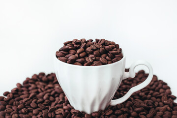 Cup with fresh aromatic roasted coffee beans isolated on white background. Cope space
