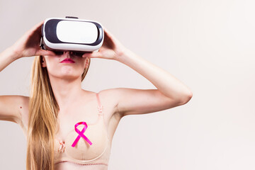 Girl in bra pink cancer ribbon and vr box