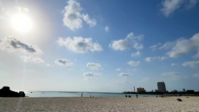CHTAN-CHO, OKINAWA, JAPAN - JUNE 2021 : View of Araha beach (Ocean or sea). Wide view time lapse zoom tracking shot in daytime. Holiday, vacation and resort concept shot.