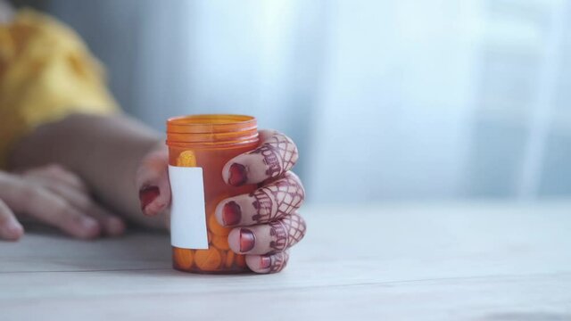 child hand hold medicine pill container 