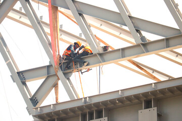 Fototapeta premium Working at Heights Safely, Workers building a train station at Thailand Bangkok.