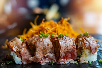 wagyu beef sushi On the black plate (Japanese style restaurant food menu) 