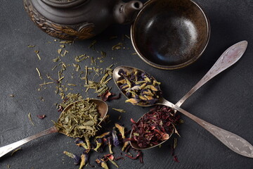 Various kinds of dry tea bancha green, Hibiscus, Butterfly Pea flower tea in spoons on the table