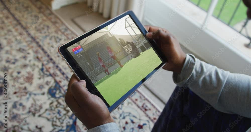 Canvas Prints Composite of man sitting at home, watching hockey match on tablet