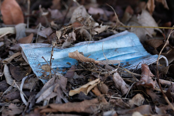 Closeup of a surgical mask on the ground