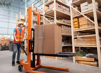 Warehouse man worker with manual forklift. Warehousing, machinery concept. Logistics in stock.