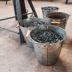 Three coal buckets on the floor