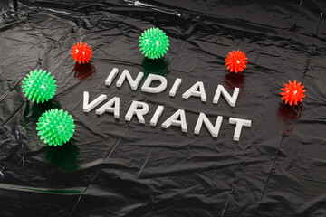 words indian variant laid with silver metal letters on crumpled black plastic bag background with...
