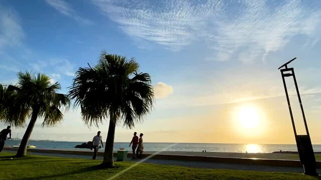 CHTAN-CHO, OKINAWA, JAPAN - JUNE 2021 : View of Araha beach (Ocean or sea) in sunset time. Wide view time lapse tracking shot, dusk to night. Holiday, vacation and resort concept shot.