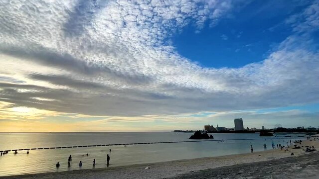 CHTAN-CHO, OKINAWA, JAPAN - JUNE 2021 : View of Araha beach (Ocean or sea) in sunset time. Wide view time lapse tracking shot, dusk to night. Holiday, vacation and resort concept shot.