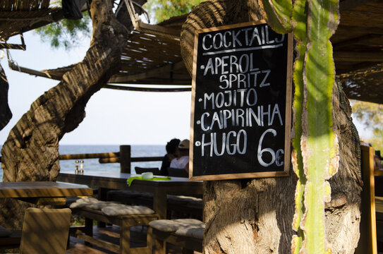 Price list of restaurant beverages on the tree trunk