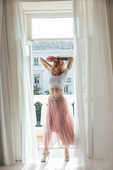 beautiful blonde woman dancing posing at the door window