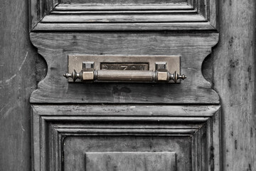 A old vintage wooden exterior grey door with mailbox. horizontal Letter box
