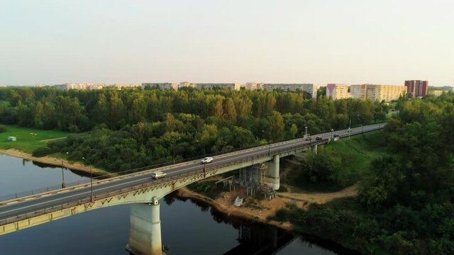 Aerial Shot of Novopolotsk, Belarus, Europe. Car Bridge across Western Dvina or Daugava River in Summer. 4K Pedestal Background Drone view Video