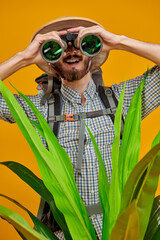 biologist  looks through binoculars