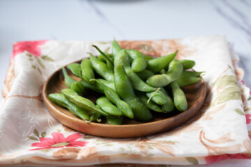 Japanese food edamame nibbles, boiled green soy beans