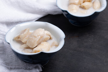 Banana in Coconut Milk , Thai Dessert (Kluay Buat Chi) on black background