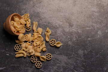 Raw pasta lines on gray background. Top view.