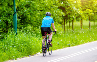 Fototapeta premium Cyclist ride on the bike path in the city Park 